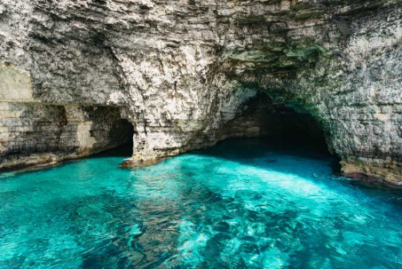 Amazing Charters boat anchored in the turquoise waters of the Blue Lagoon, Comino, Malta